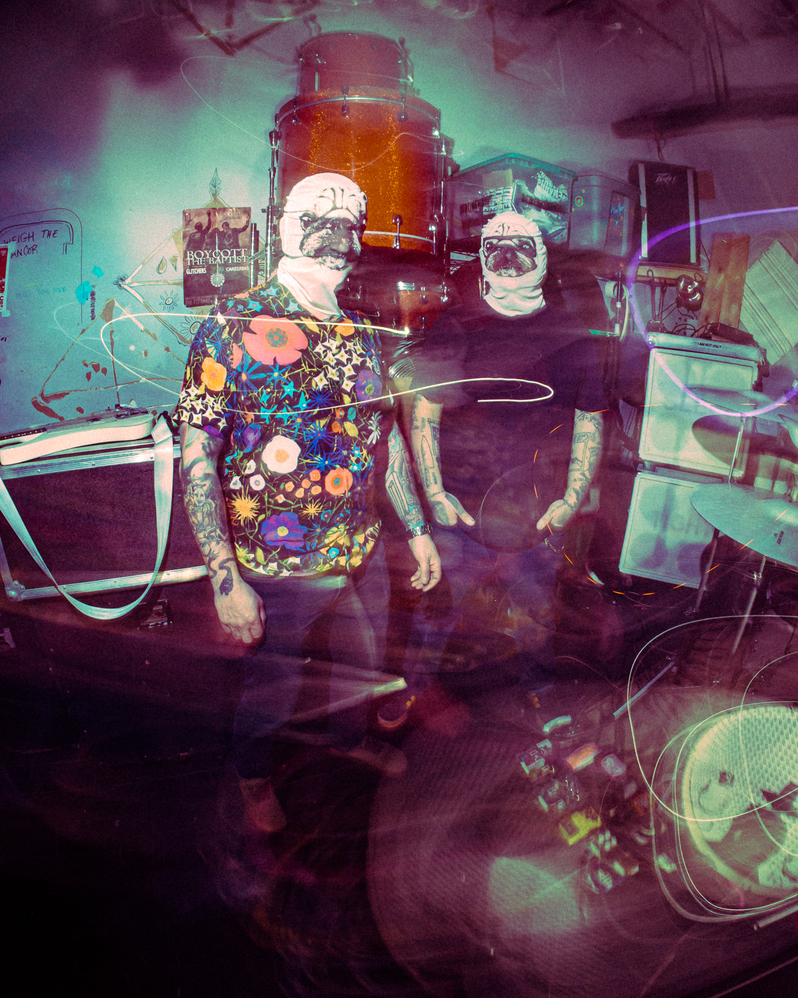 BEDTIMEMAGIC performing in dog masks beside a drum kit